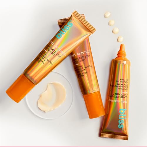 Bliss Rest Assured Eye Cream tube dispensing tiny dots for precise application.