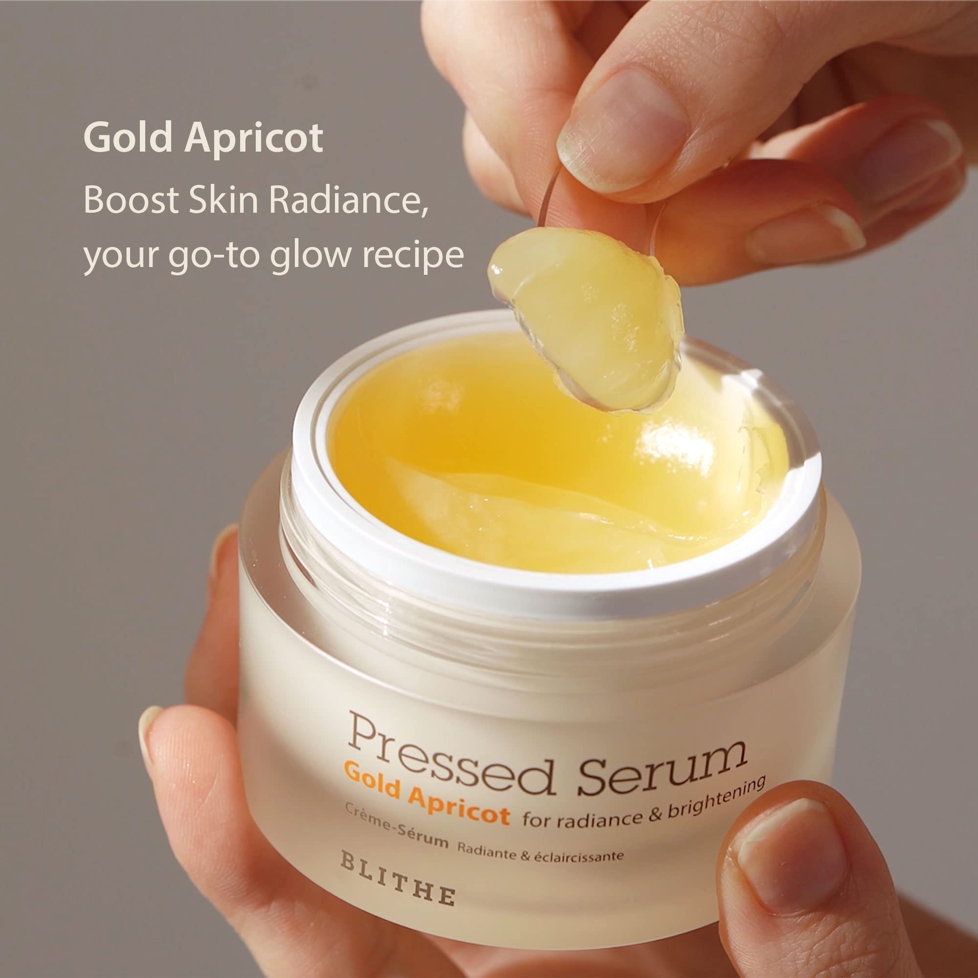 BLITHE Pressed Serum Gold Apricot glass-skin finish on skin swatch.