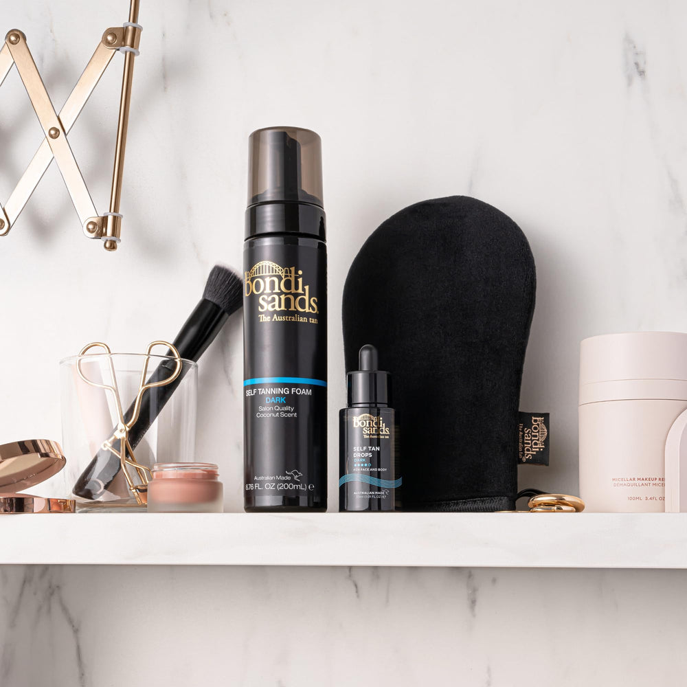 Applying Bondi Sands Drops to the face for natural shade.