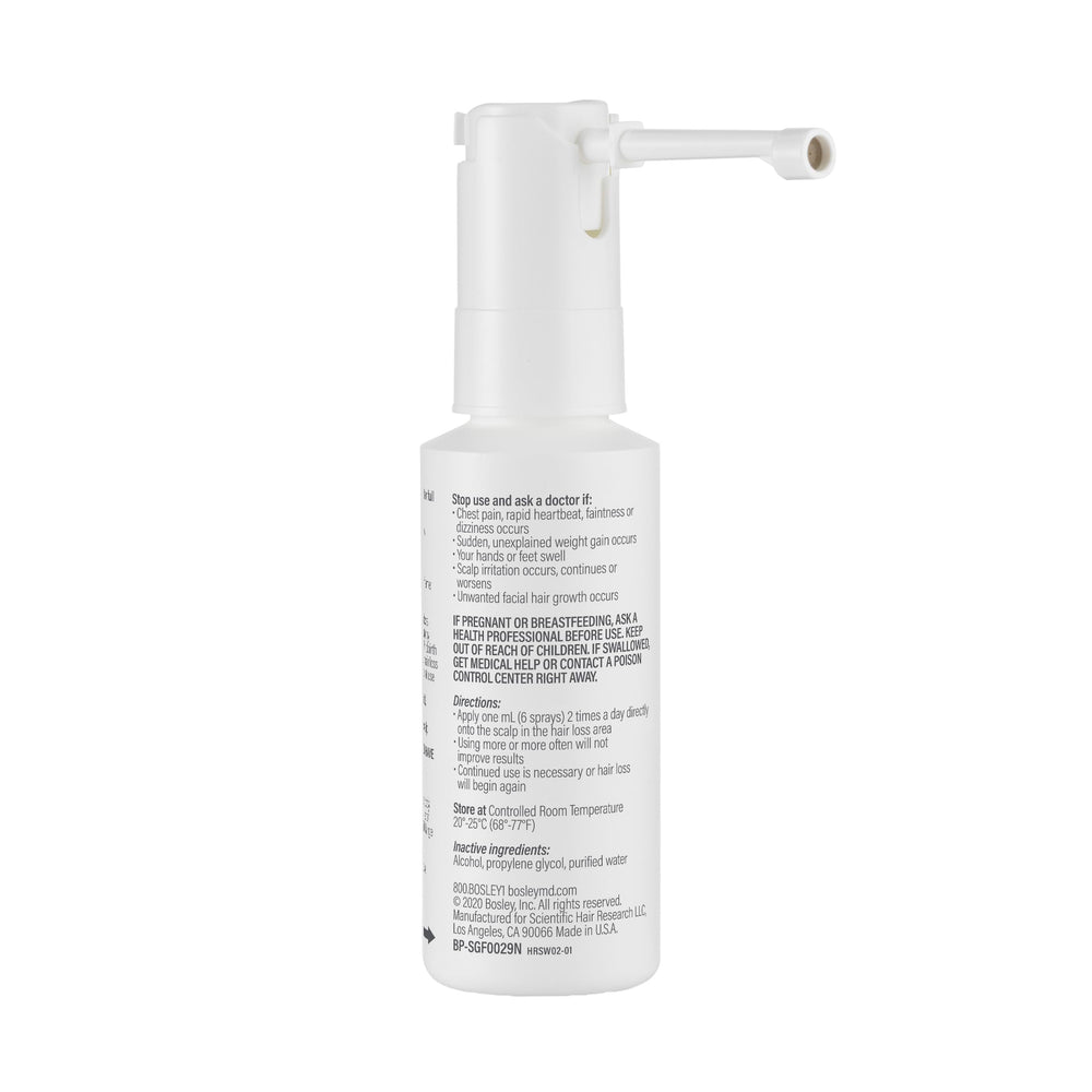 BosleyMD Minoxidil Woman Spray user in front of mirror ready to apply.