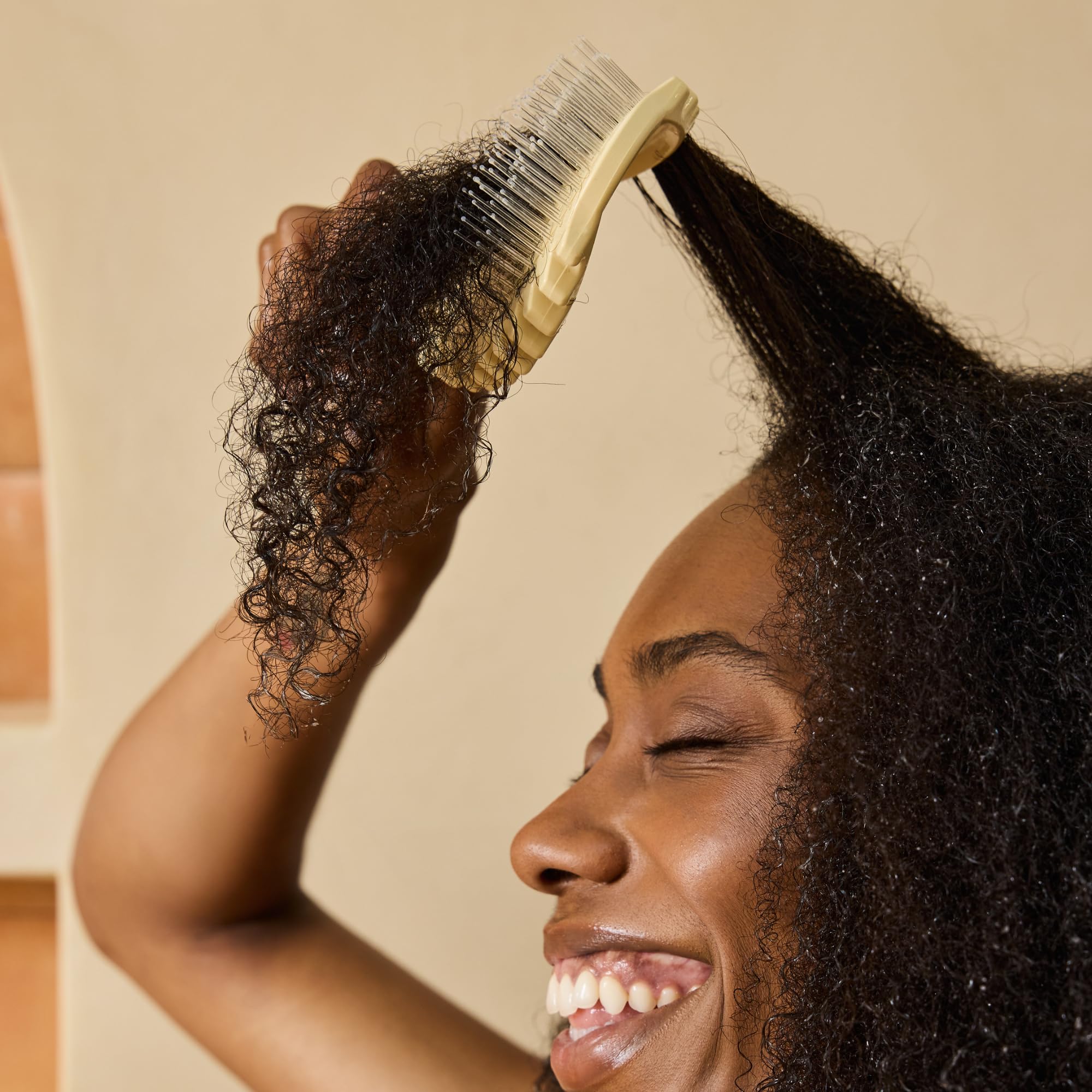 Bounce Curl brush used in shower with conditioner for gentle wet detangling benefits