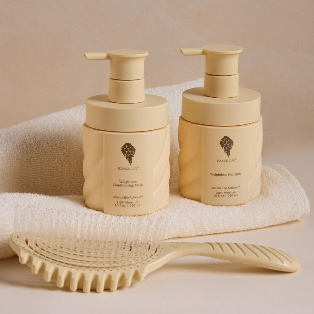 Bounce Curl brush on bathroom counter in lifestyle scene showing salon-quality home use