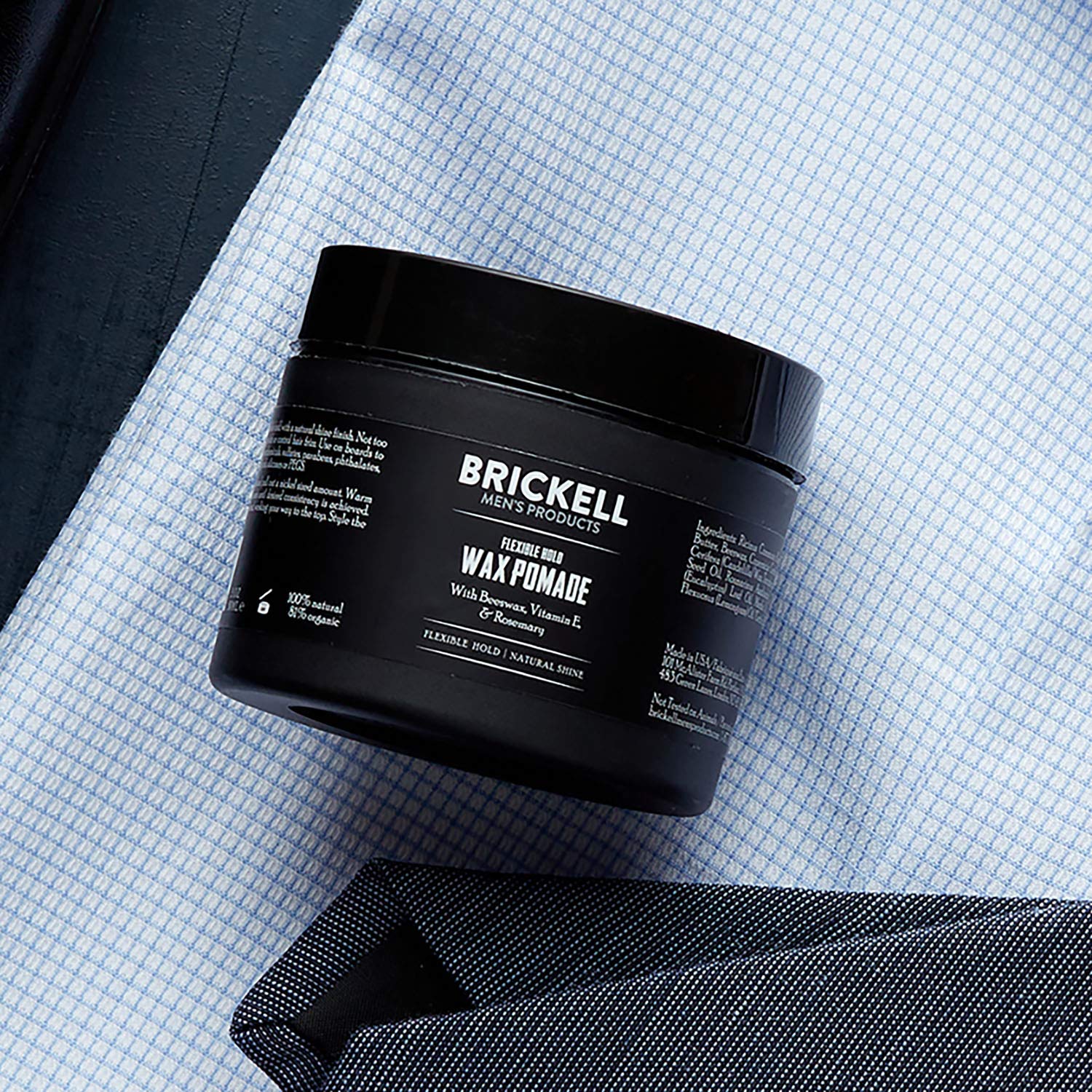 Brickell Men's Flexible Hold Pomade hands applying demonstrates easy styling and flexible hold.
