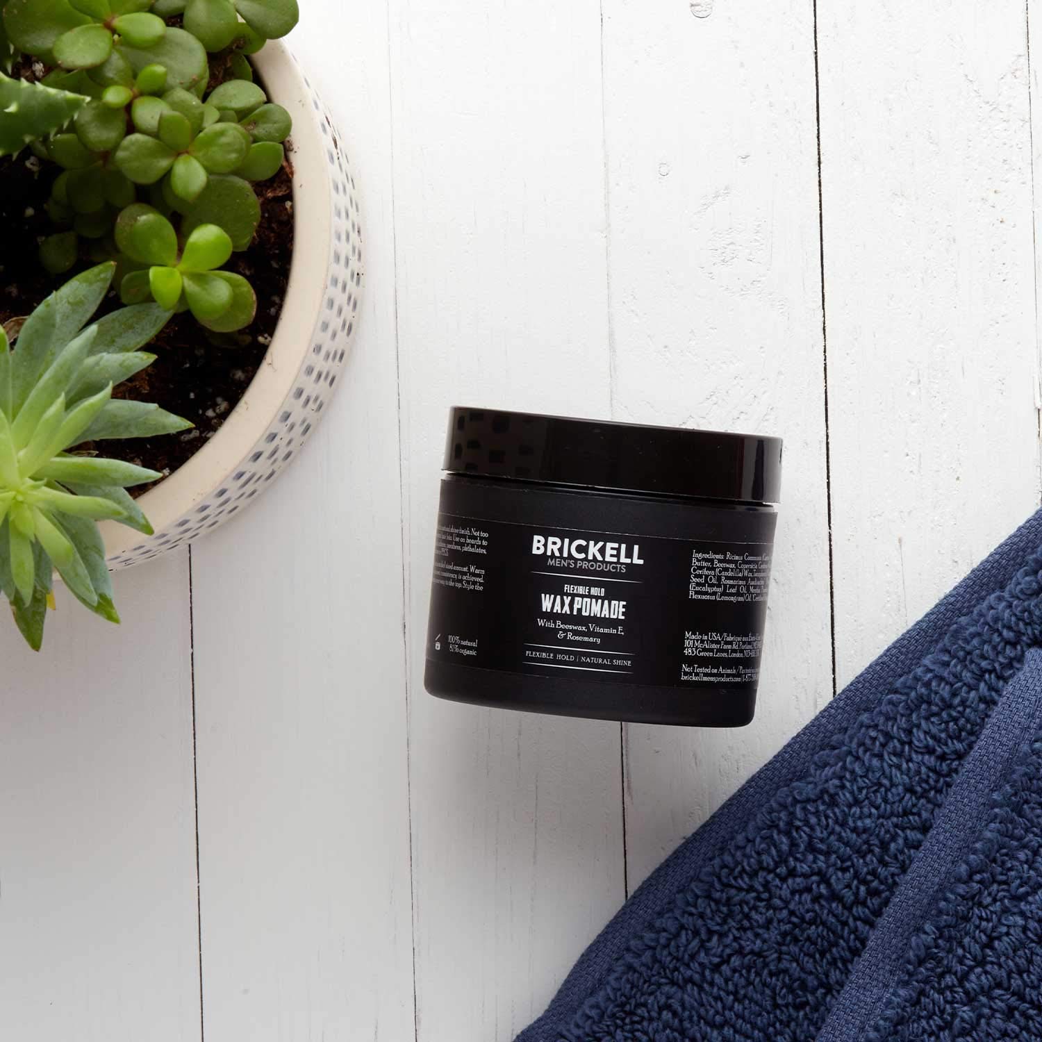 Brickell Men's Pomade packaging on shelf emphasizing organic ingredients.
