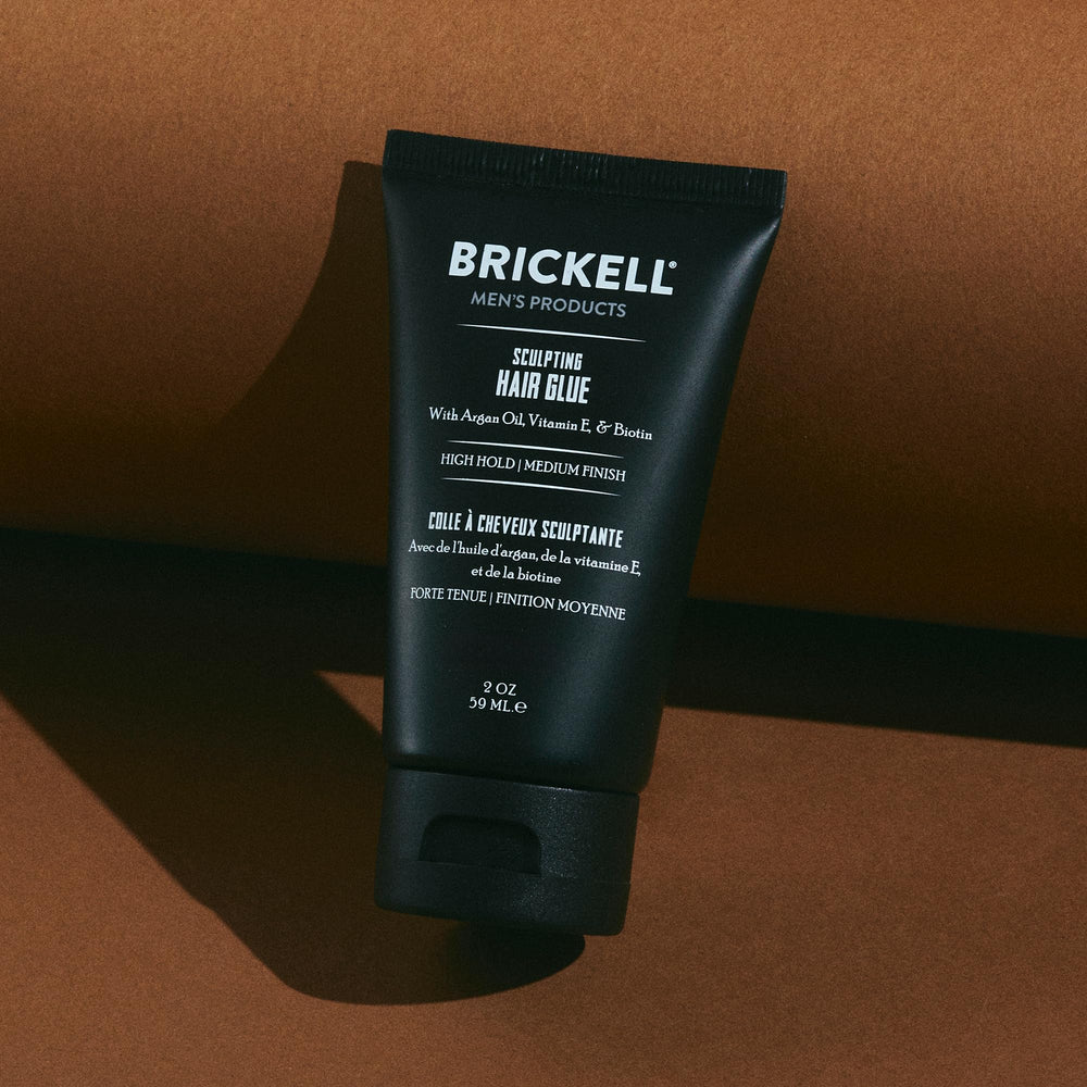 Brickell Men's Hair Glue with argan oil drop highlights nourishment.