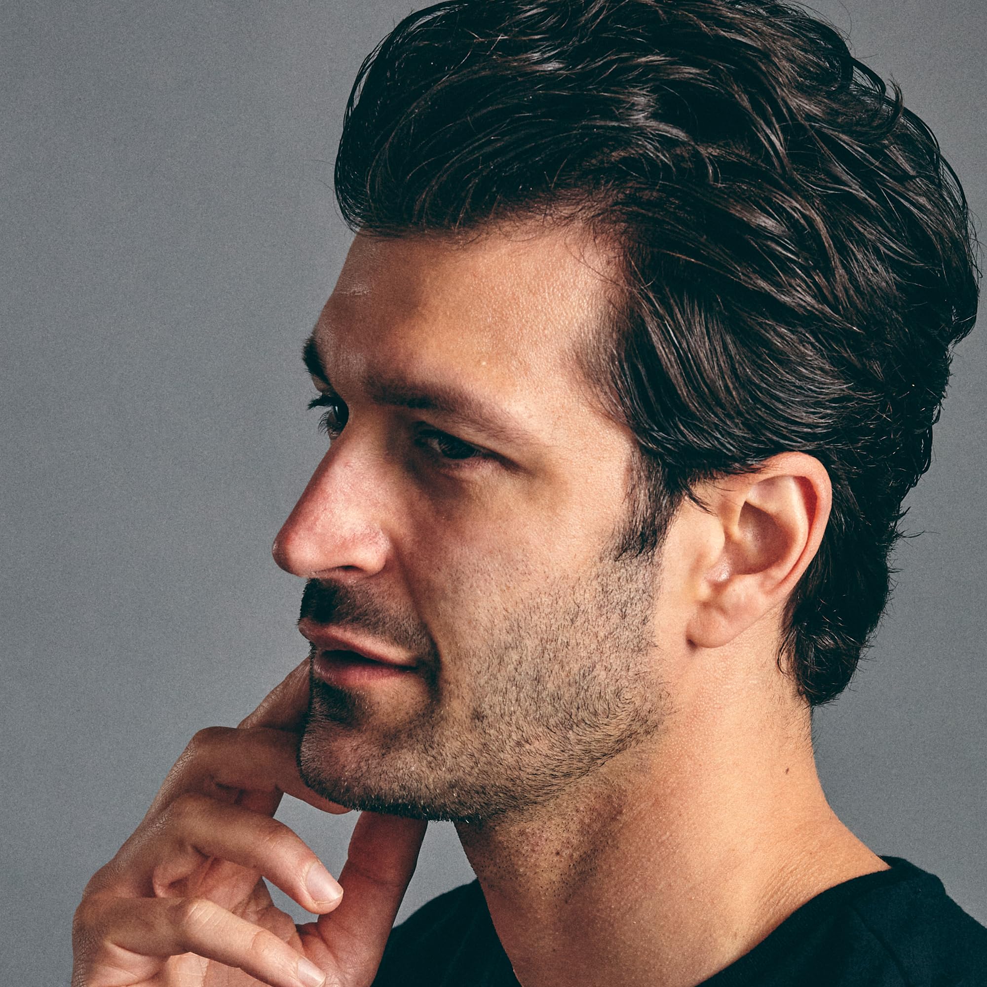Brickell Men's Hair Glue bottle graphic indicates medium shine finish.