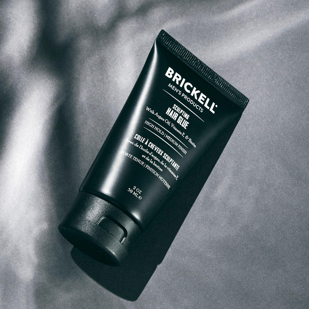 Brickell Men's Hair Glue close-up of textured style for defined finish.