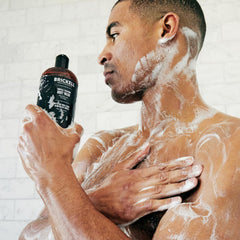 Brickell Men's Invigorating Body Wash ingredients closeup shows aloe and jojoba for moisture.