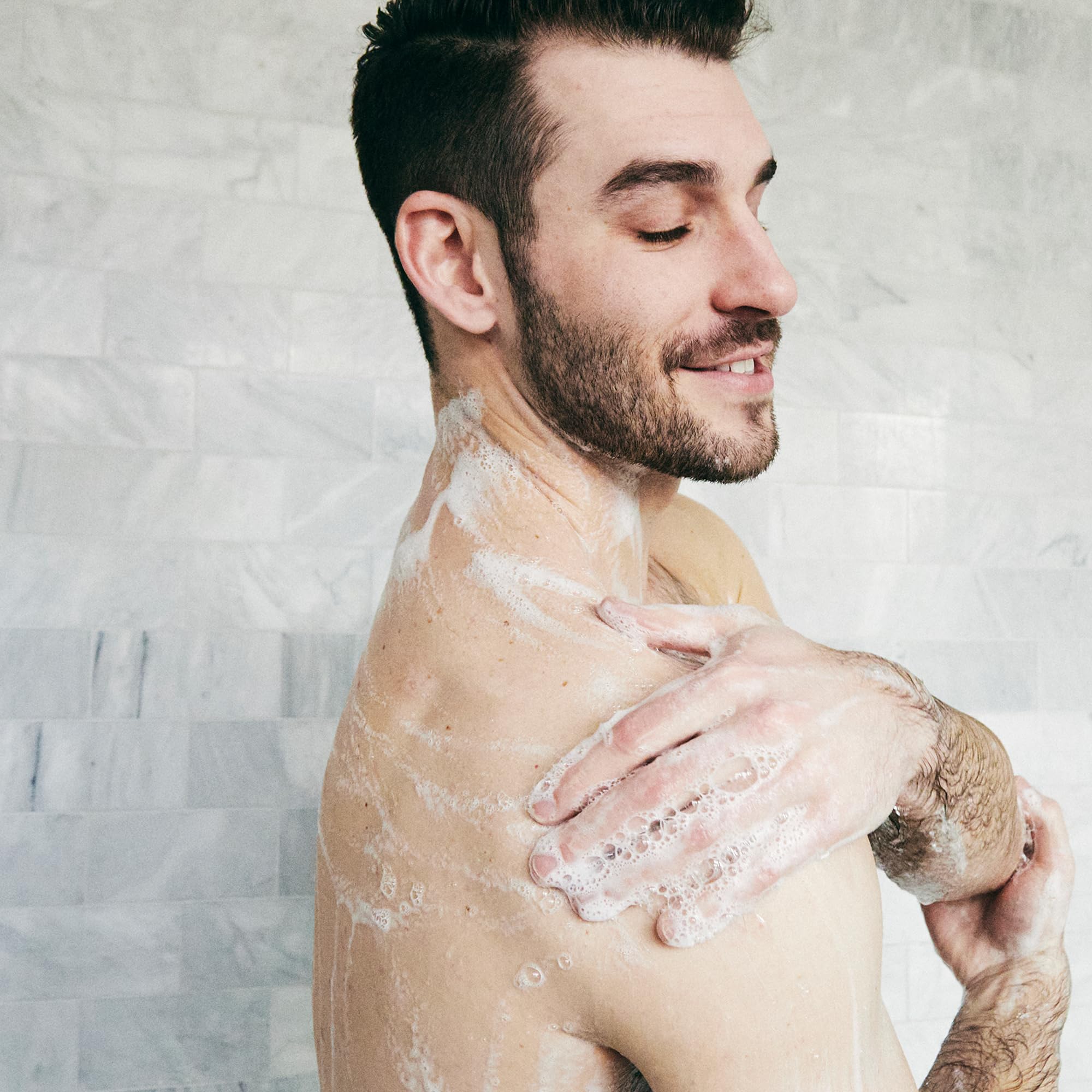 Brickell Men's Invigorating Body Wash packaging tropical teakwood scent for daily refreshment.