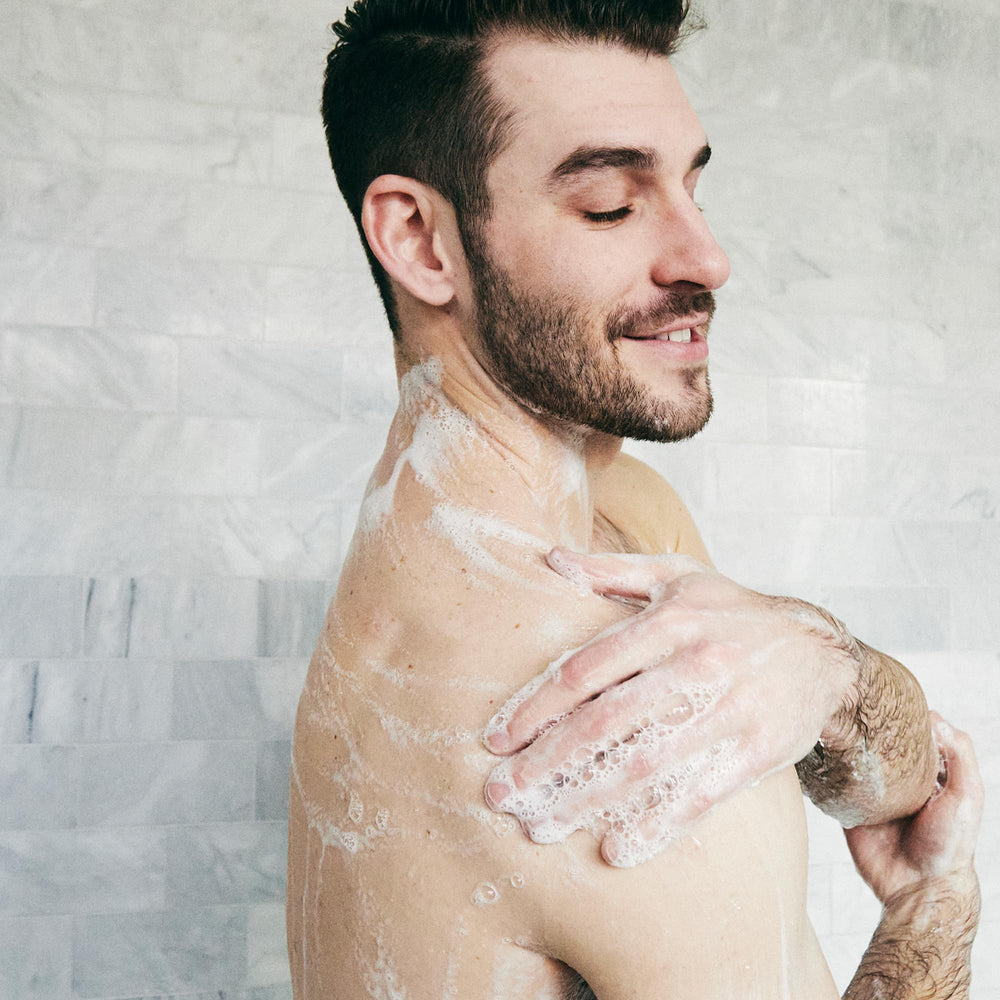 Brickell Men's Invigorating Body Wash packaging tropical teakwood scent for daily refreshment.