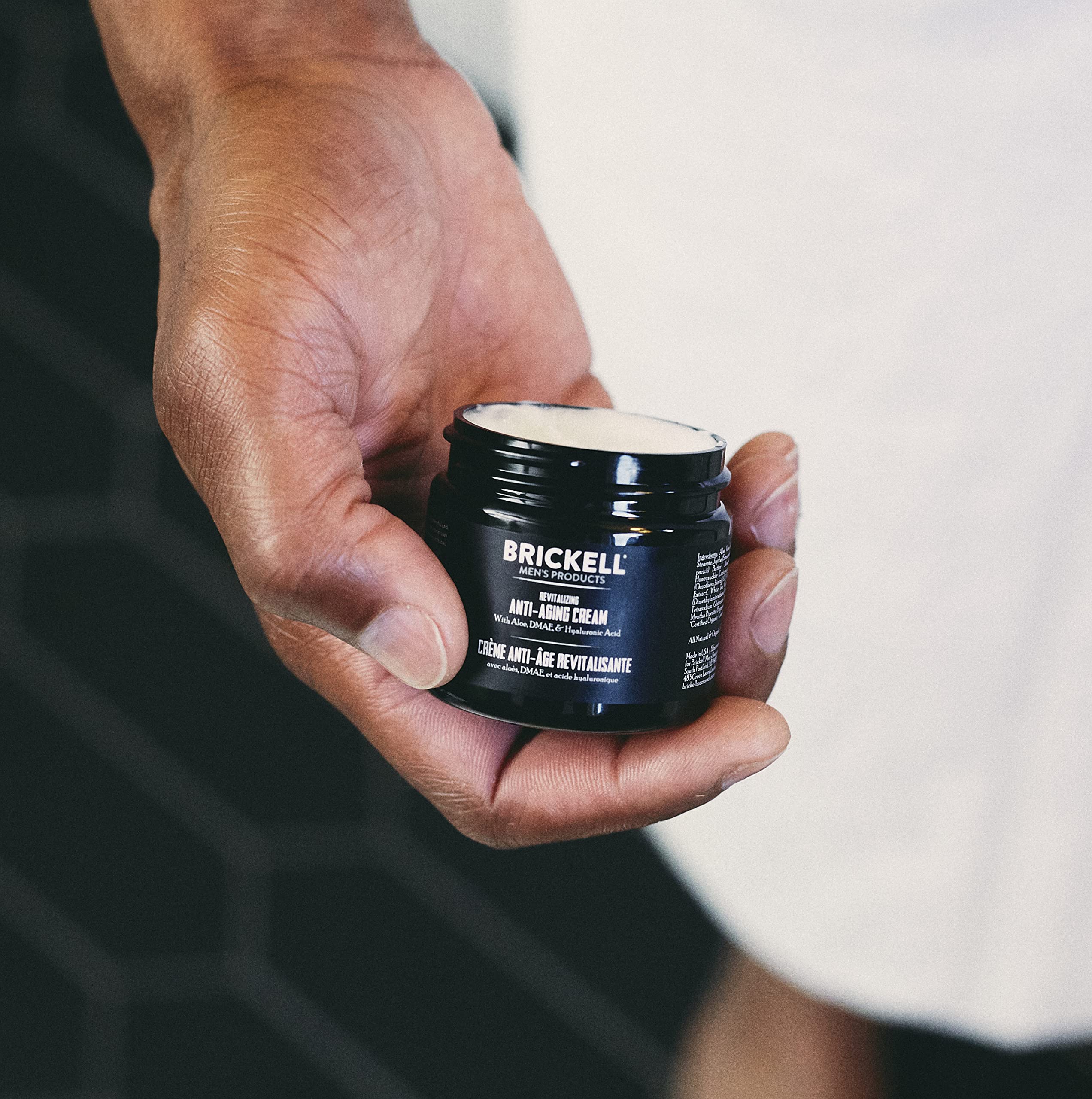 Brickell Men's Night Cream application shown for overnight nourishment and restoration.