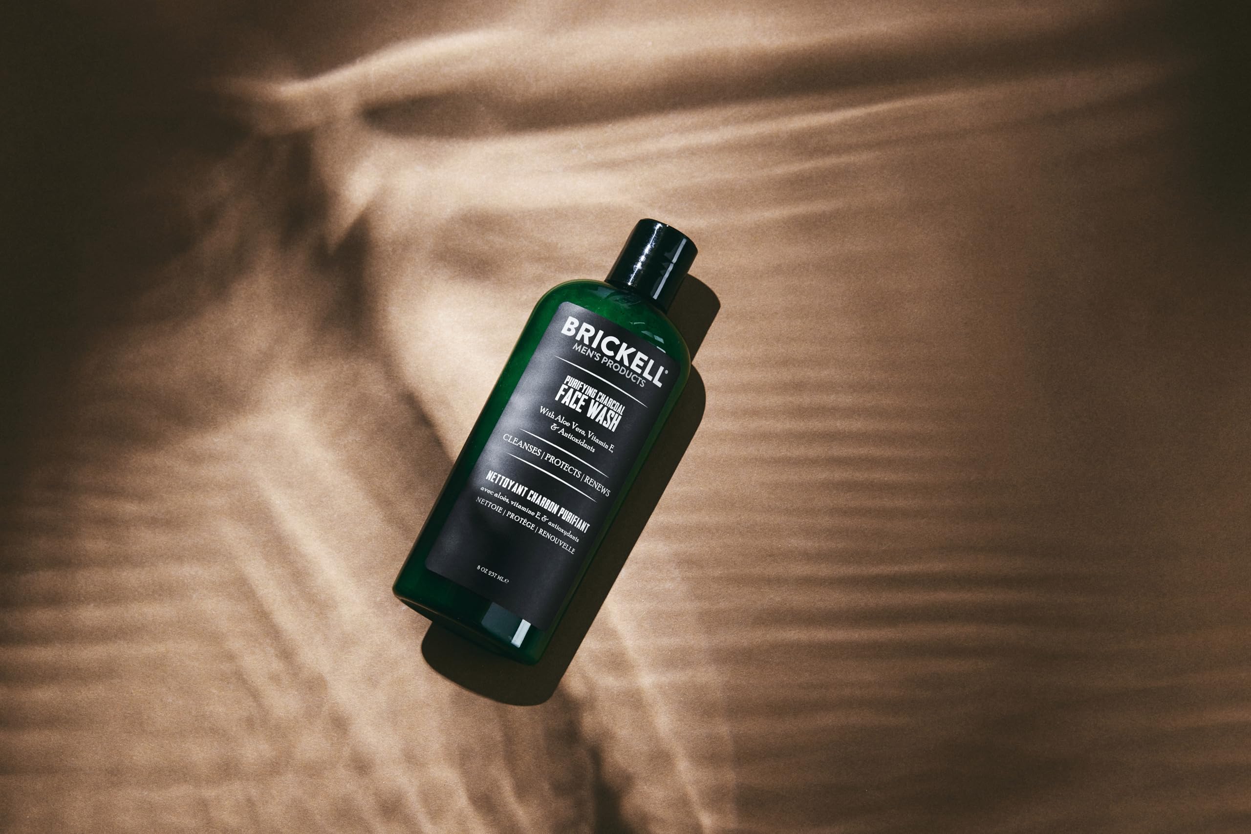 Brickell Men's Purifying Charcoal Face Wash foam close-up demonstrating gentle lather for sensitive skin