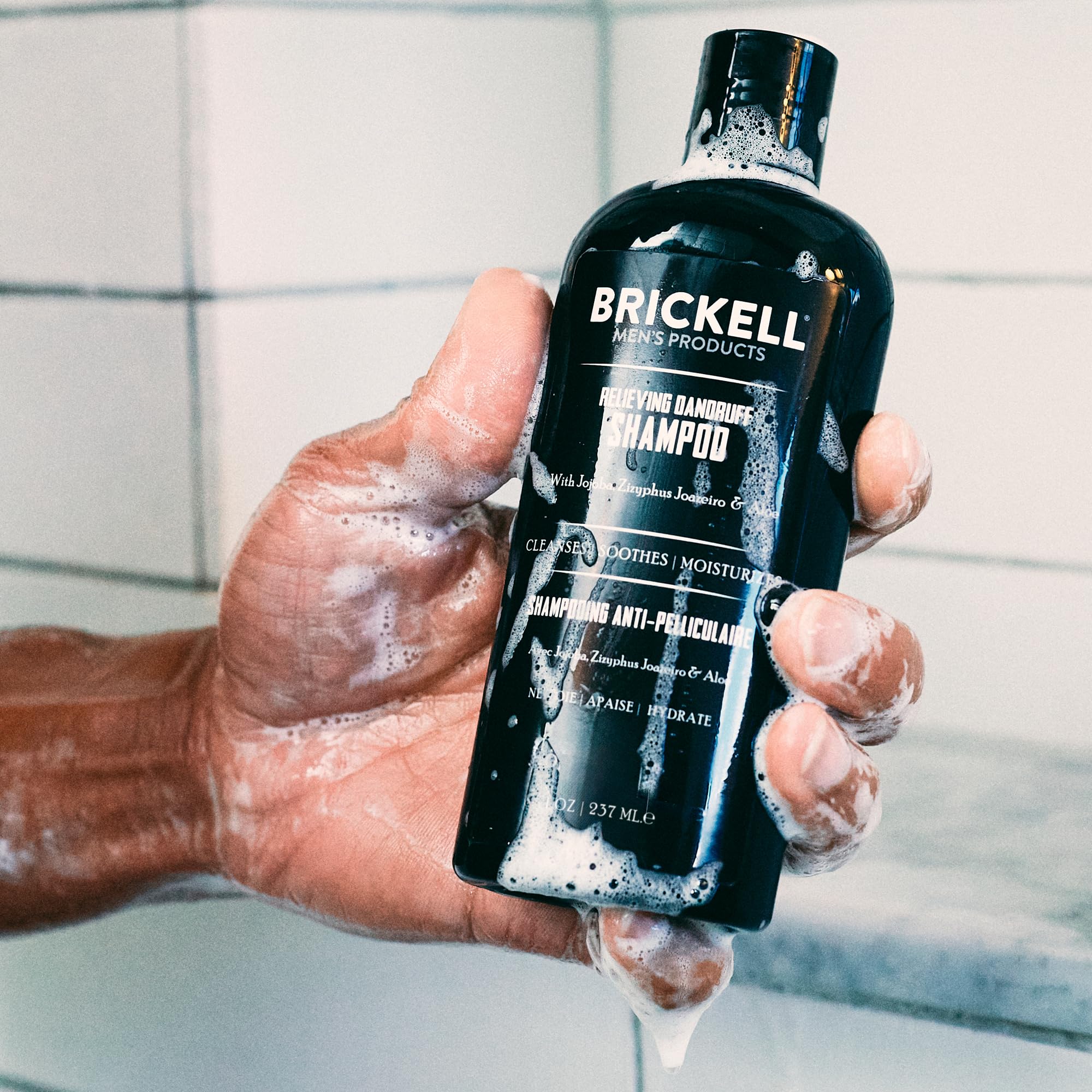 Brickell Men's Relieving Dandruff Shampoo lather closeup highlights rich foam for scalp cleansing.