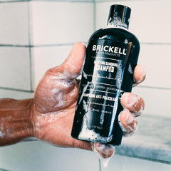Brickell Men's Relieving Shampoo ingredients closeup highlighting jojoba oil and tea tree.