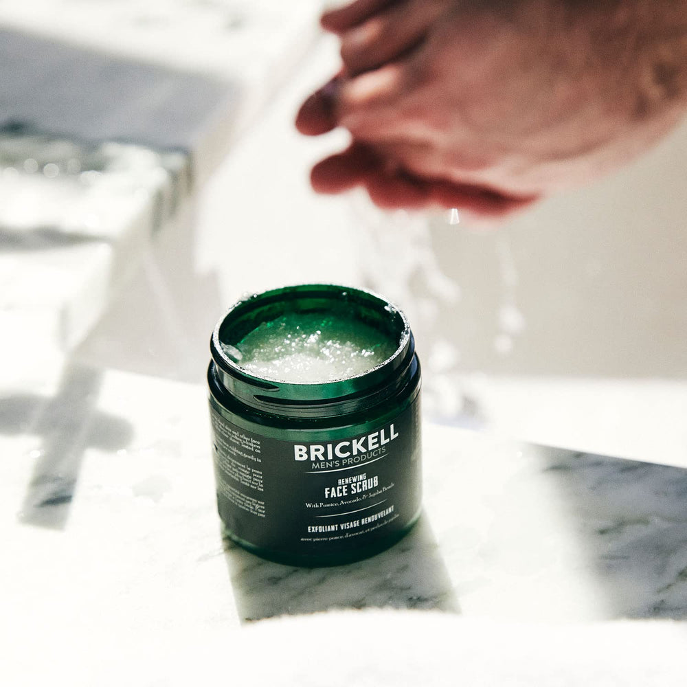 Brickell Men's Renewing Face Scrub texture shows natural exfoliants like jojoba beads and pumice.