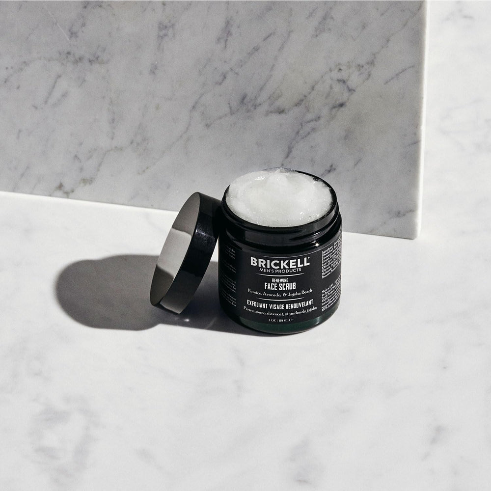 Brickell Men's Renewing Face Scrub on hand shows pre-shave prep use.