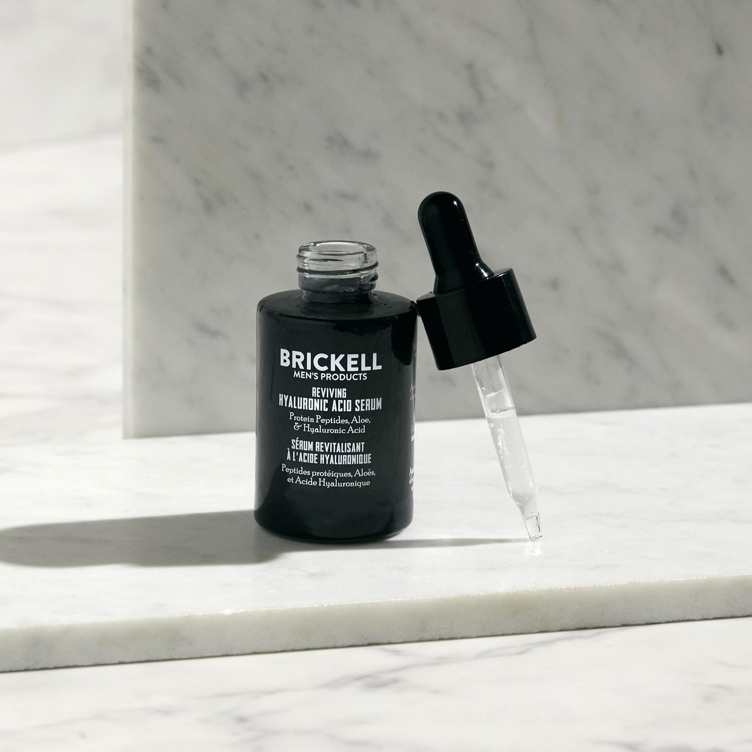 Brickell Men's serum application scene showing quick-absorbing hydration.