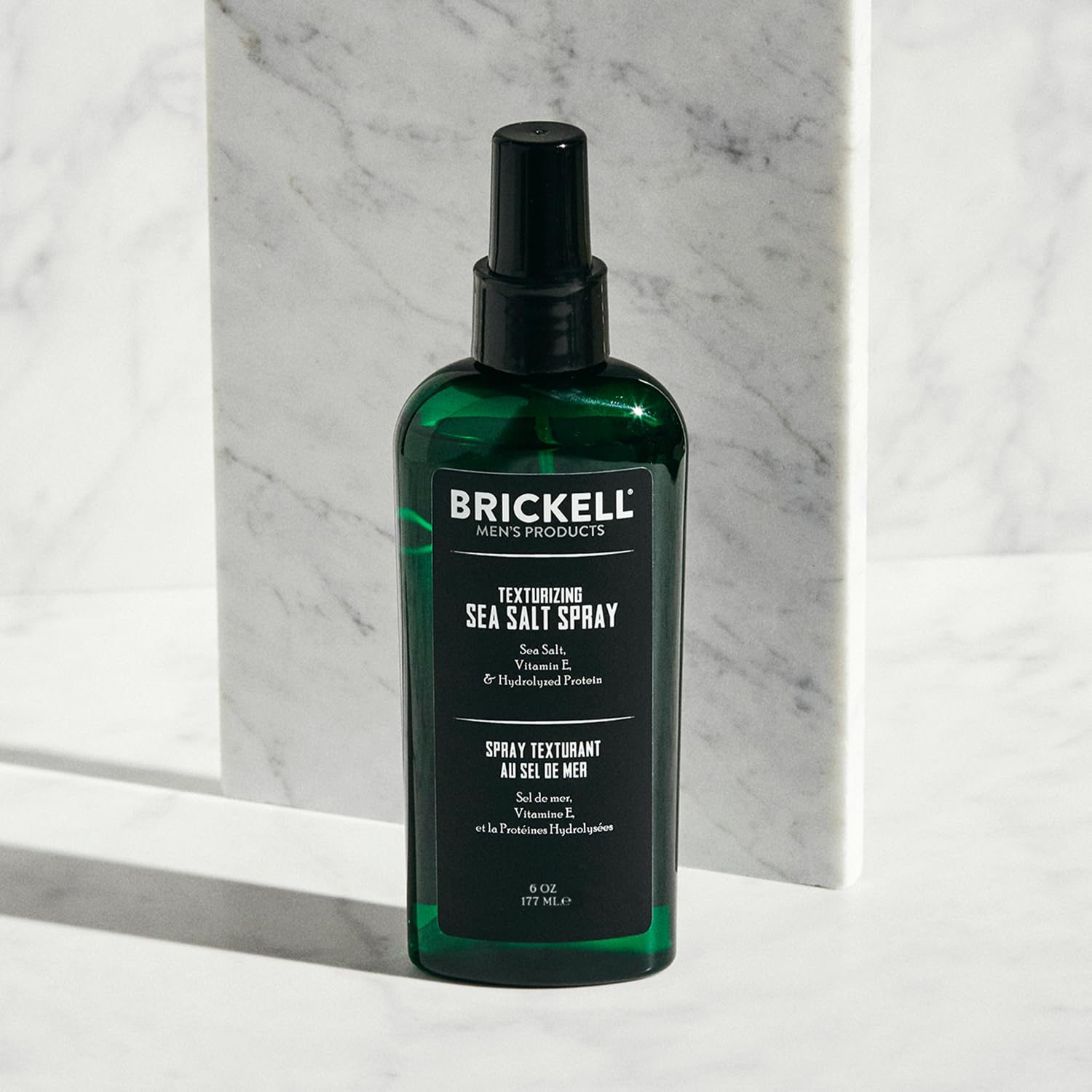 Brickell Men's Texturizing Sea Salt Spray mist on hair demonstrates lifted waves