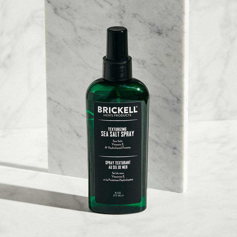 Brickell Men's Texturizing Sea Salt Spray mist on hair demonstrates lifted waves