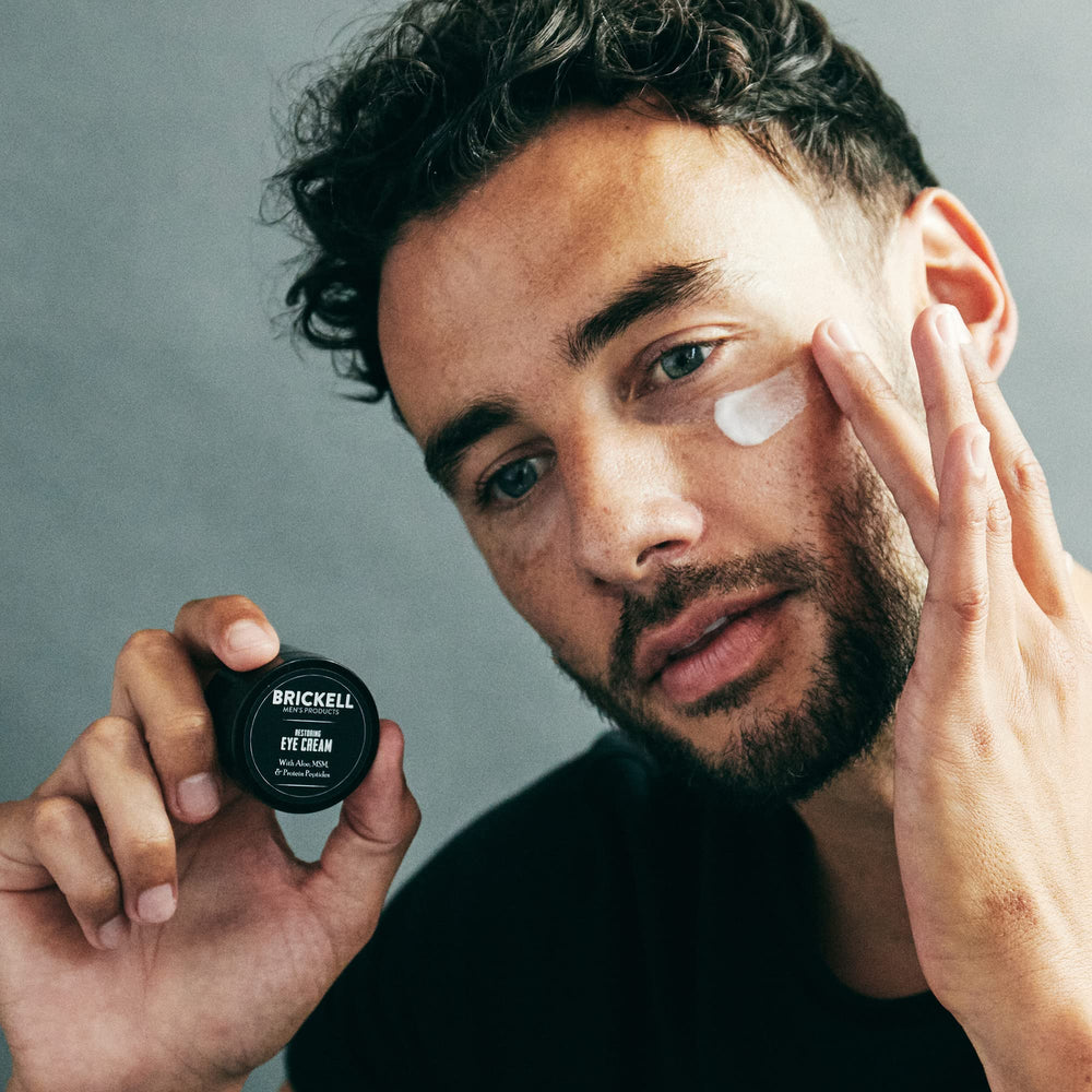 Brickell Restoring Under Eye Cream application demonstrates easy under-eye smoothing.