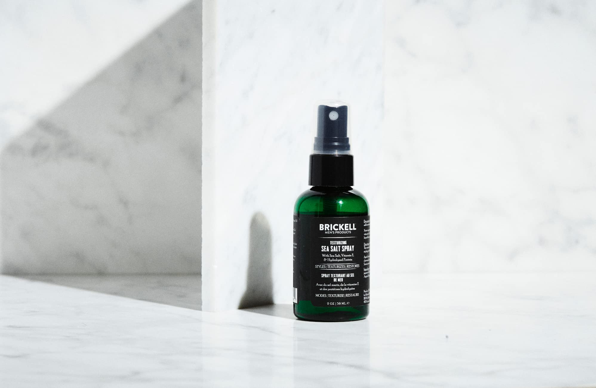 Brickell Texturizing Sea Salt Spray shows textured waves for beach-friendly styling.