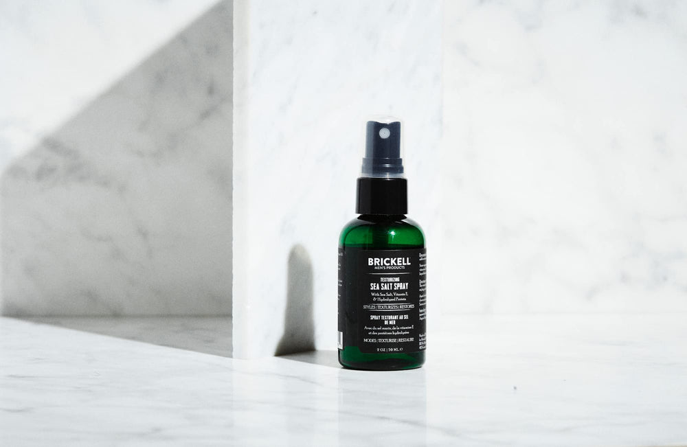 Brickell Texturizing Sea Salt Spray shows textured waves for beach-friendly styling.