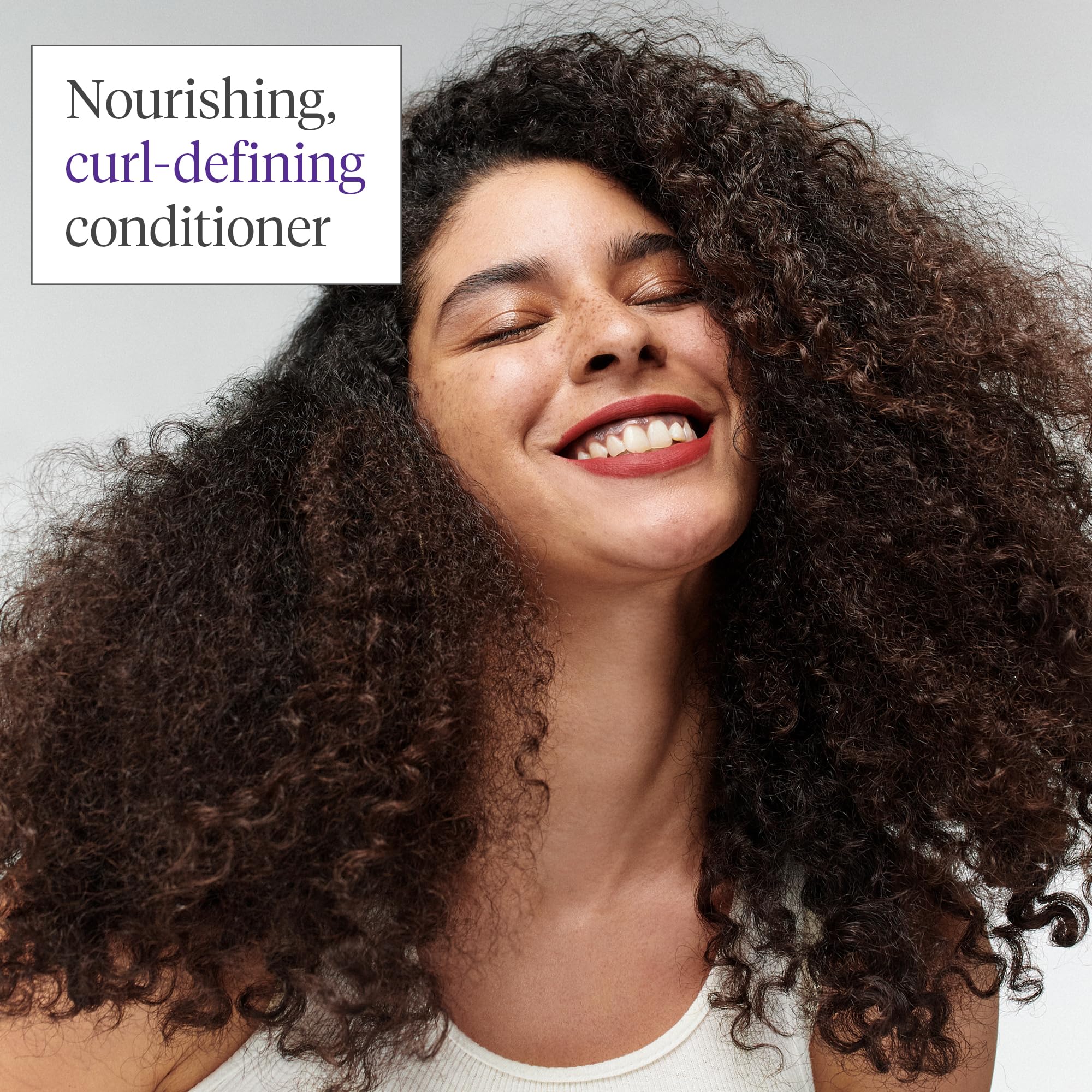Hands holding Briogeo Curl Charisma bottle suggest on-the-go frizz control and curl definition