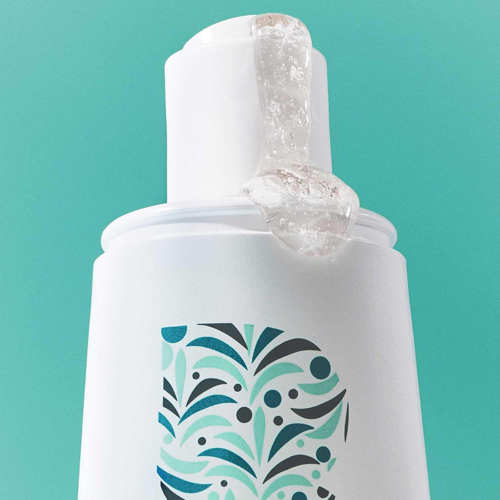 Briogeo Destined For Density bottle on sink illustrating routine-friendly packaging.