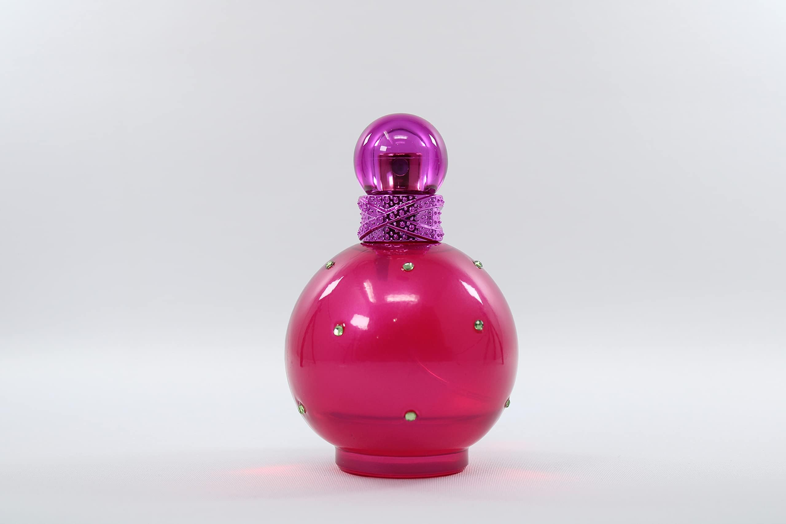 Britney Spears Fantasy bottle on surface shows elegant design perfect for vanity.