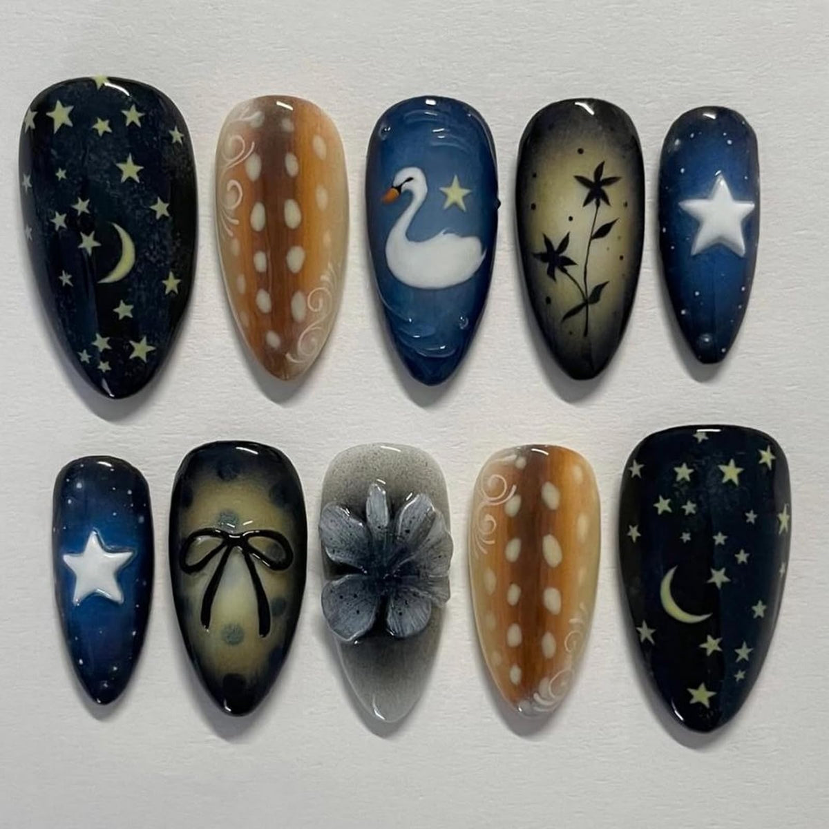 BRKYKGK medium almond nails with dark blue starry sky design for chic everyday wear