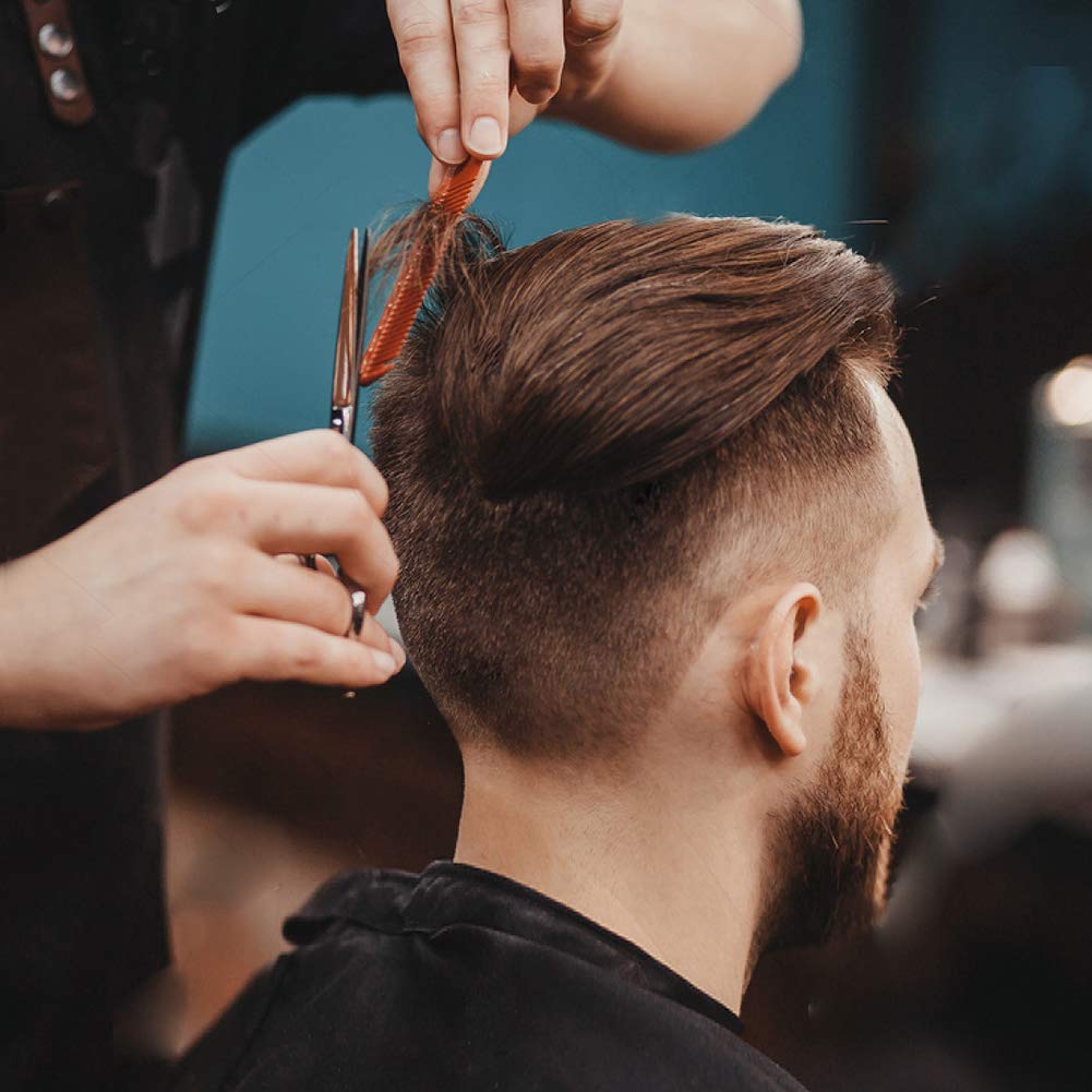 BSFHH black cape being wiped clean demonstrates easy maintenance in busy barber environments daily use