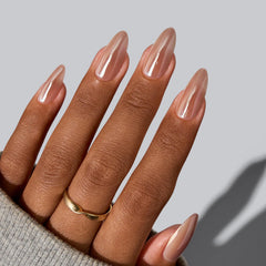 BTArtbox chocolate-glazed almond nails in motion with reflective surface.