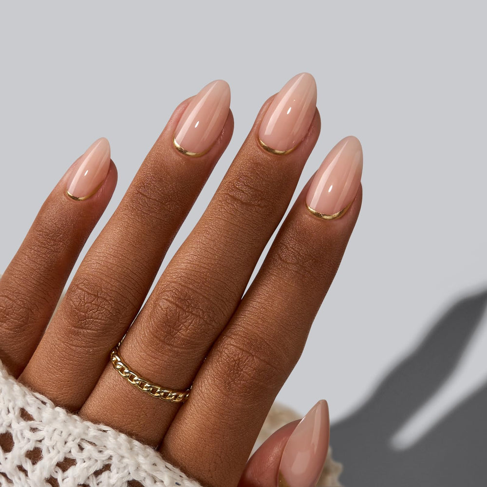 Gold foil detail on BTArtbox nails with subtle glow under indoor lighting.
