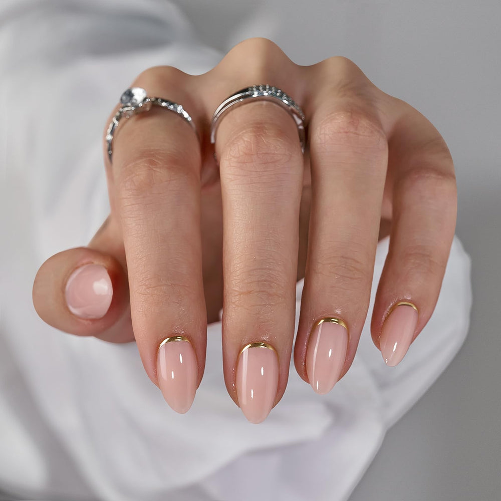 BTArtbox press-on almond nails with gold foil on nude base for subtle everyday shimmer.