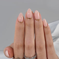 BTArtbox almond nails close-up showing gold foil shimmer for low-key glam.