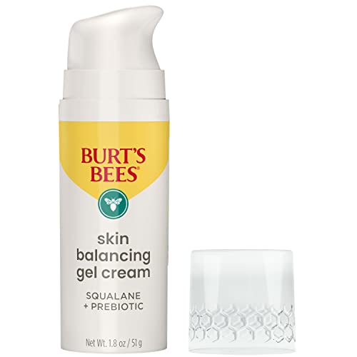 Burt's Bees bottle resting on bathroom shelf with other skincare products.