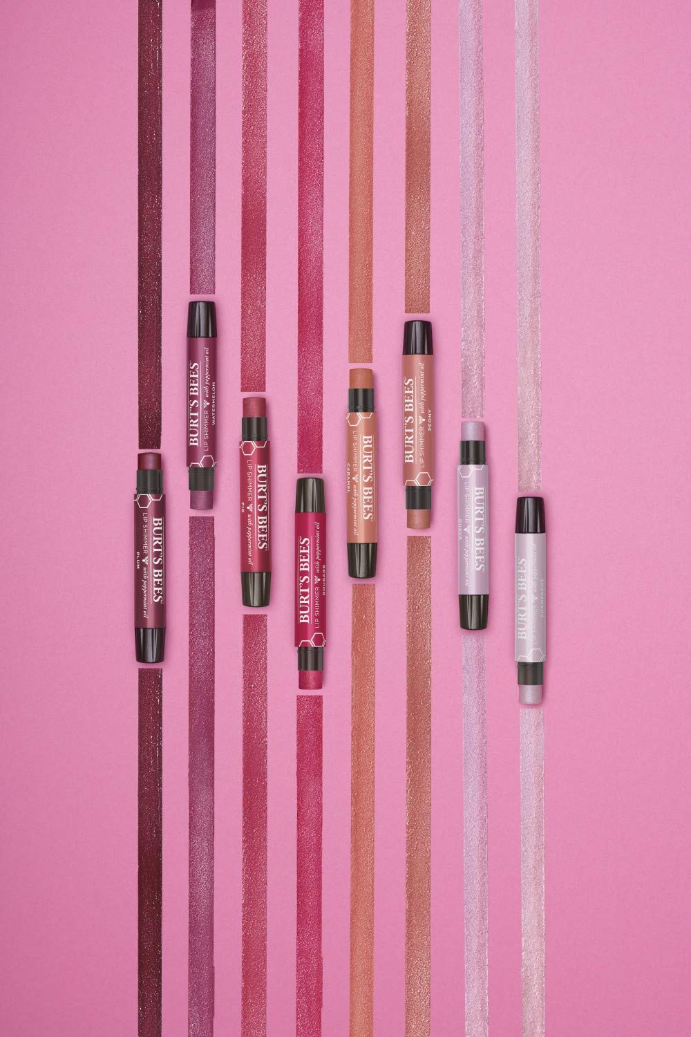 Burt's Bees Lip Shimmer Guava in hand shows travel-friendly size.