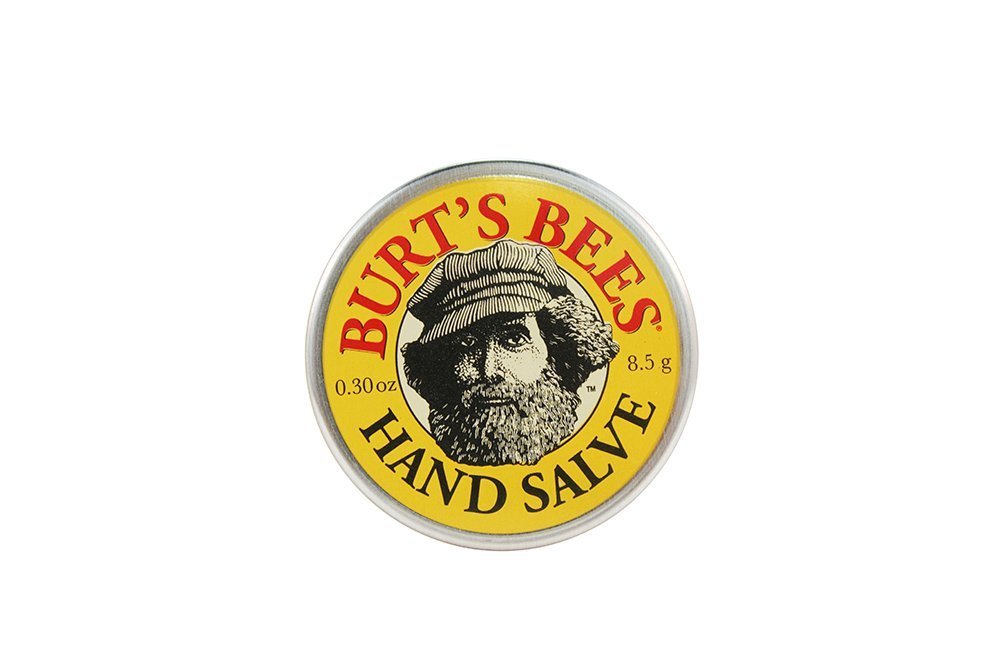 Burt's Bees Mini Hand Salve tin pictured with purse for quick, natural moisture relief