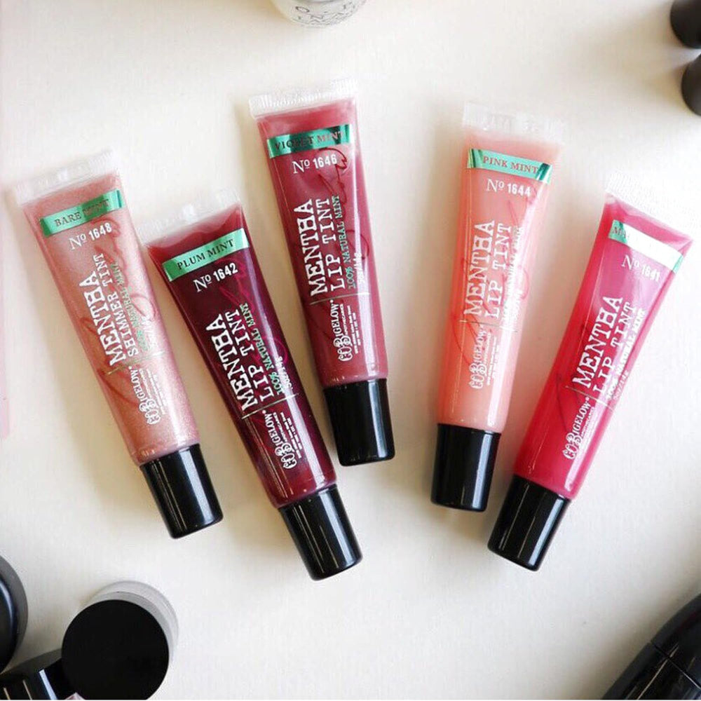 C O Bigelow Plum Mentha Lip Tint at desk for quick lip care