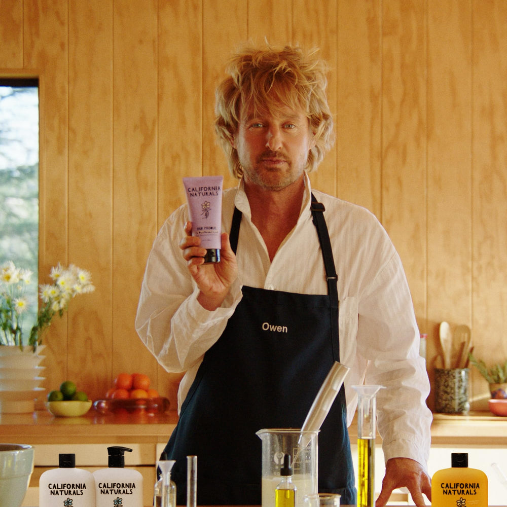 California Naturals Mens Re:GRO conditioner dispensed cream texture on hand for easy application.