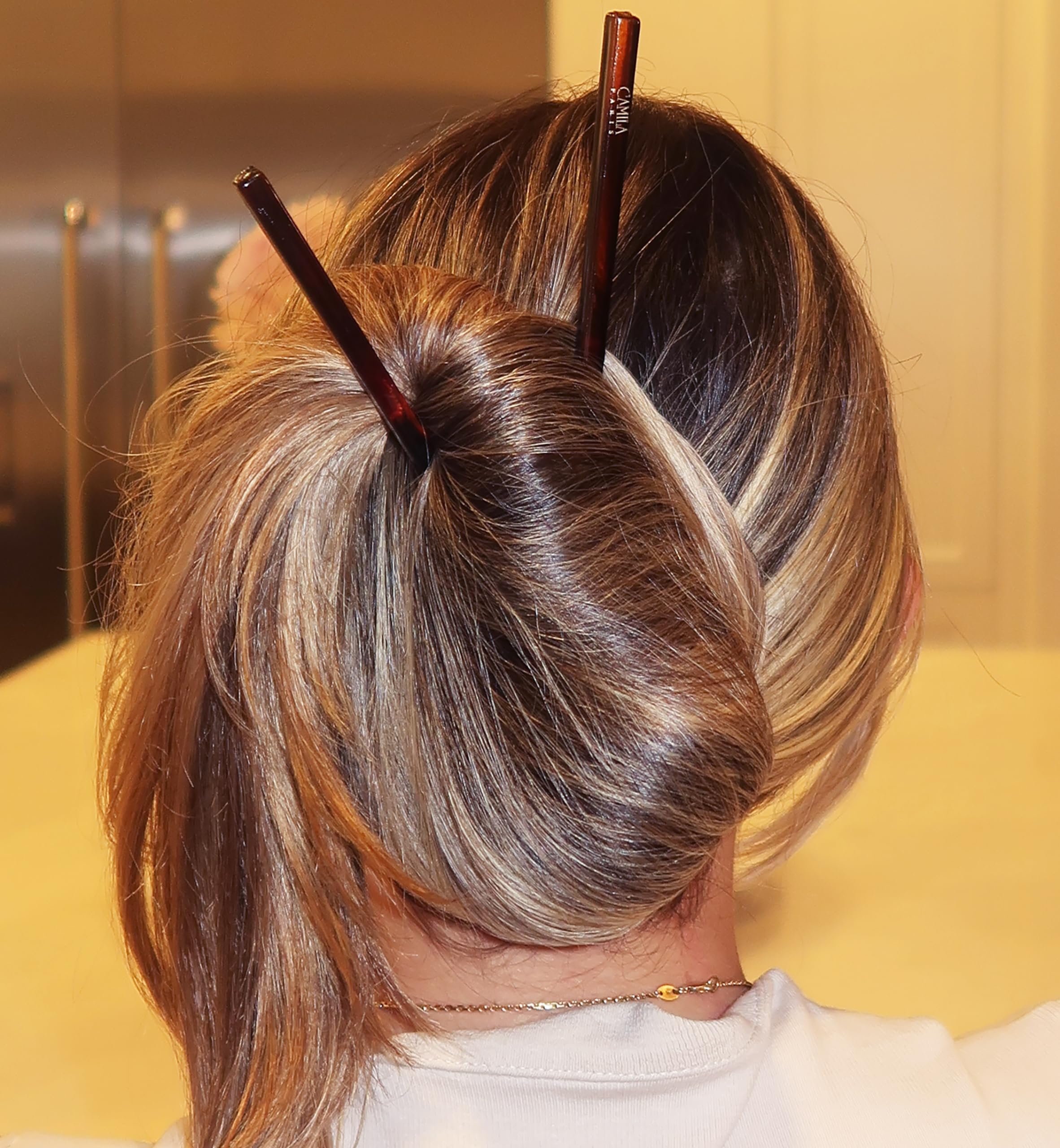 Camila Paris AD28/2 hair pin securing a chic bun updo without slippage.