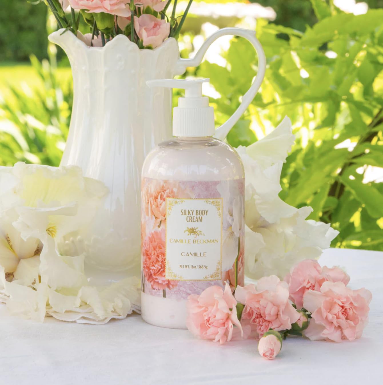 Camille Beckman Camille Scented Silky Body Cream hands-application for skin nourishment.