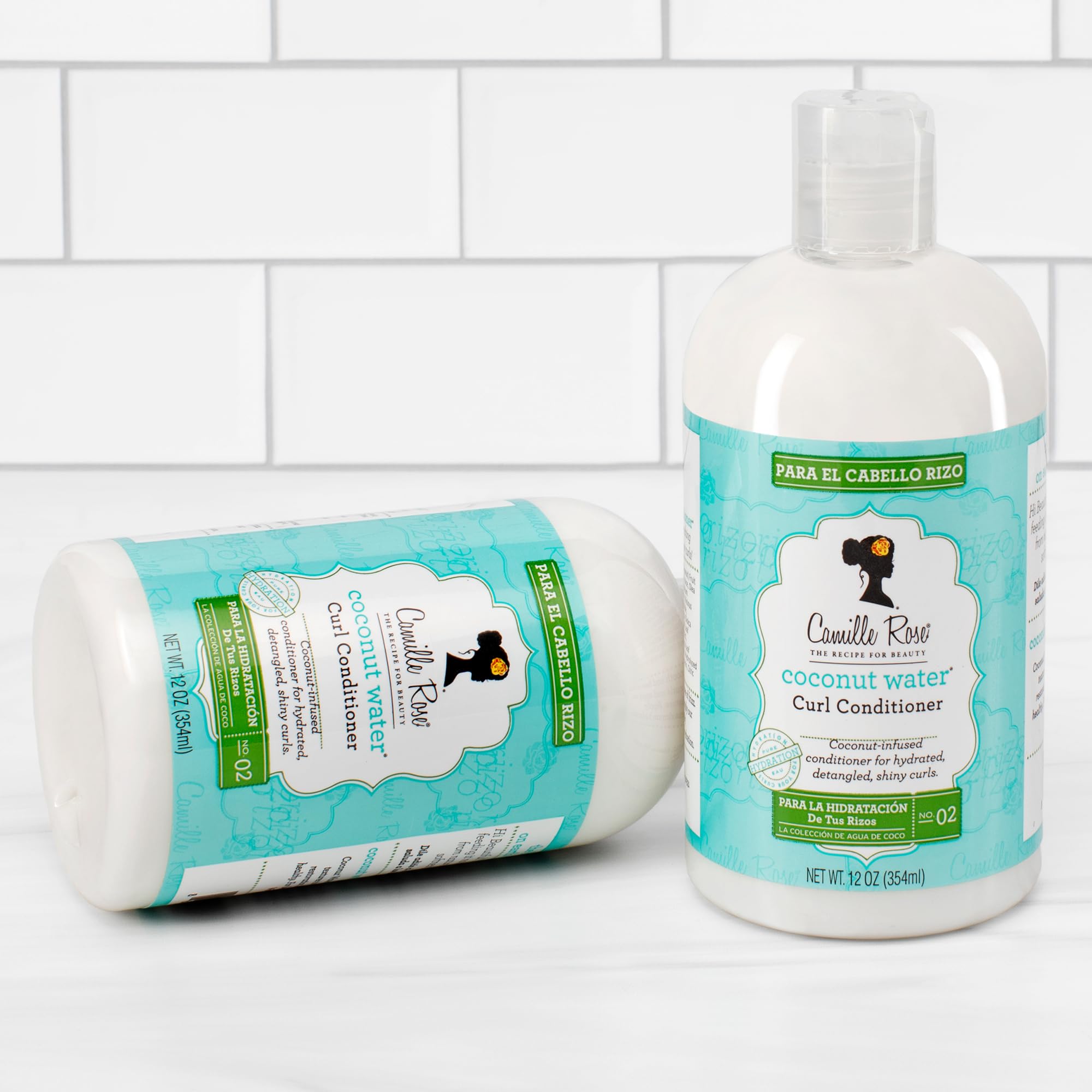 Camille Rose Coconut Water Curl Cleanse close-up on wet strands signaling hydration