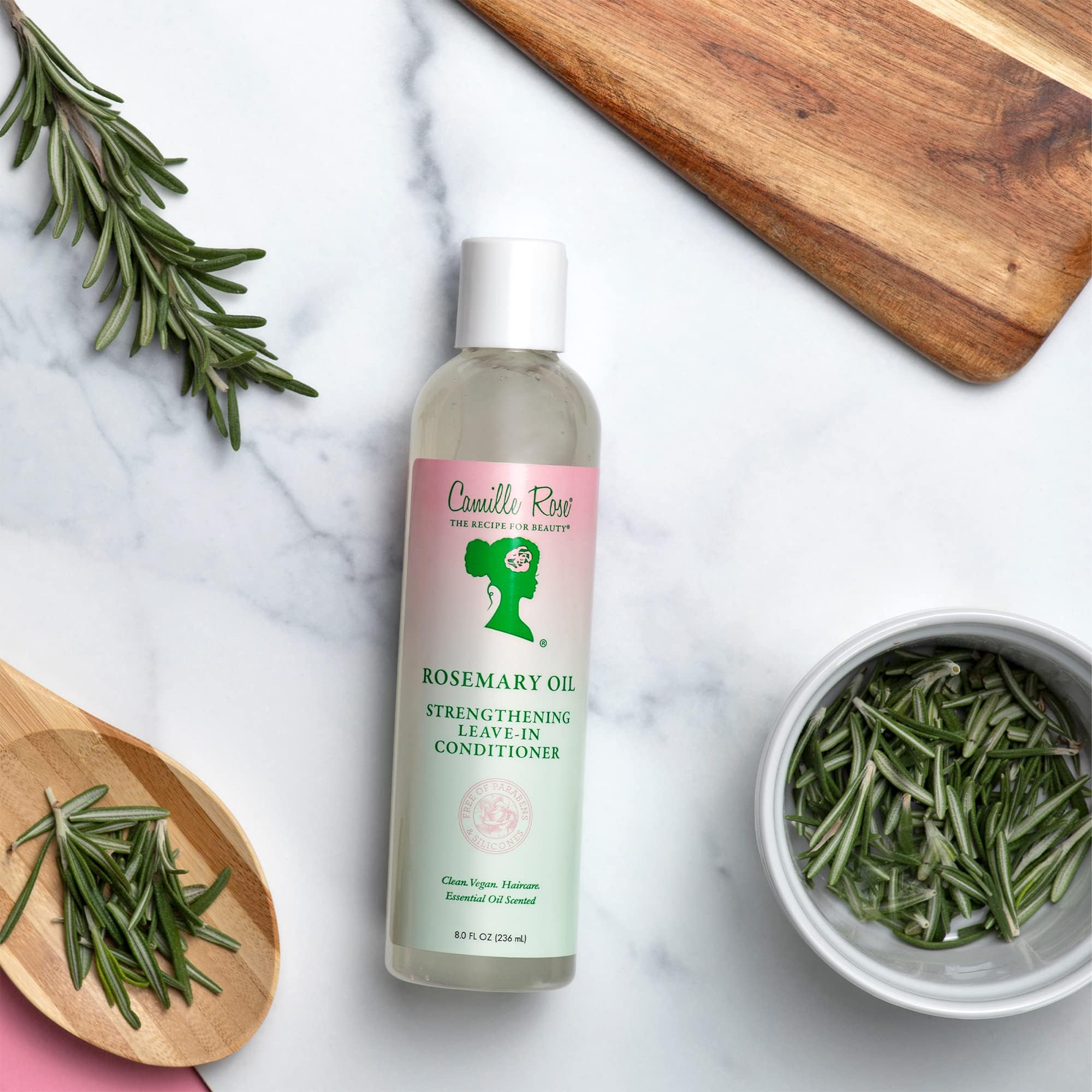 Camille Rose rosemary leave-in application on damp hair shows quick absorption.