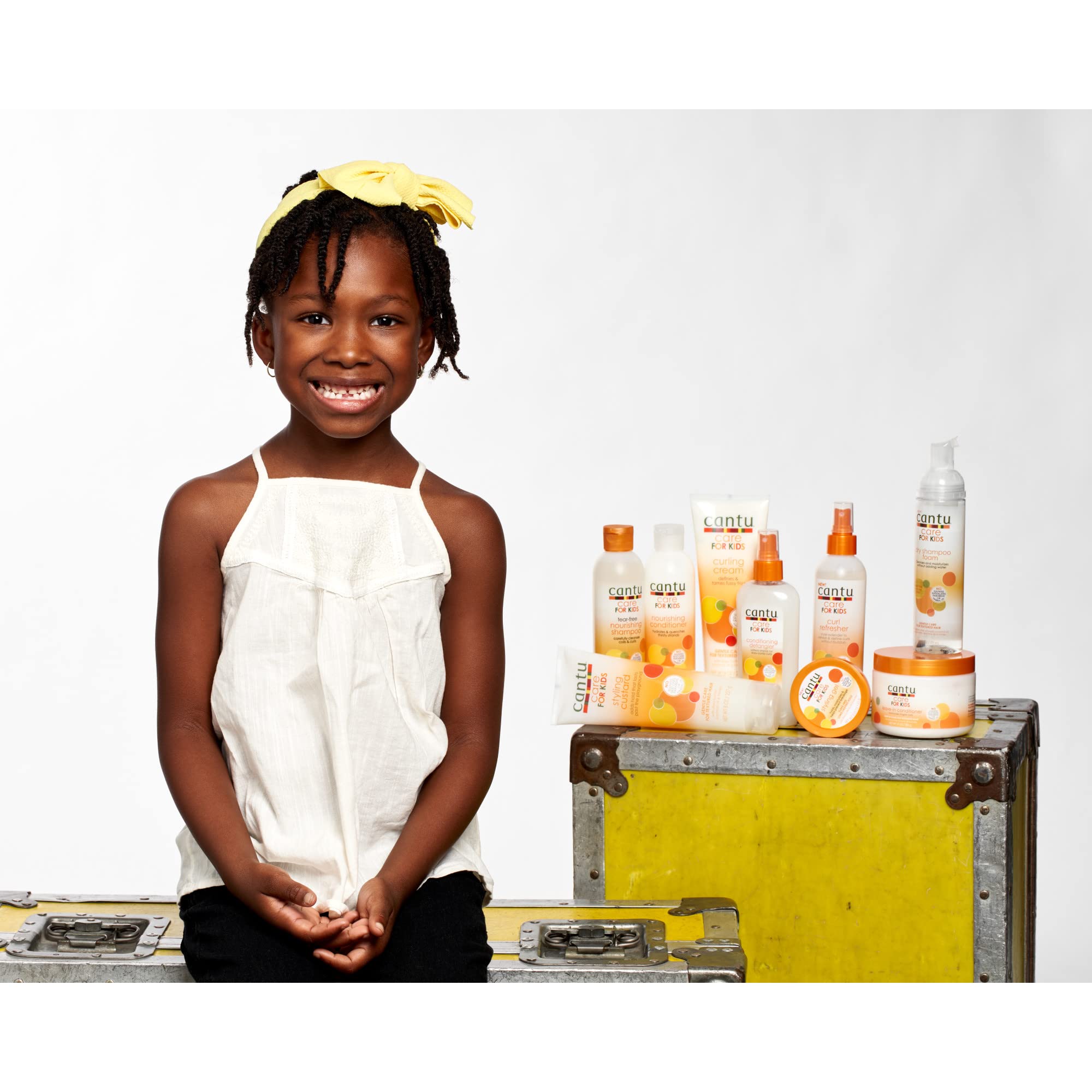 Applying Cantu Leave-In Conditioner to damp hair during routine