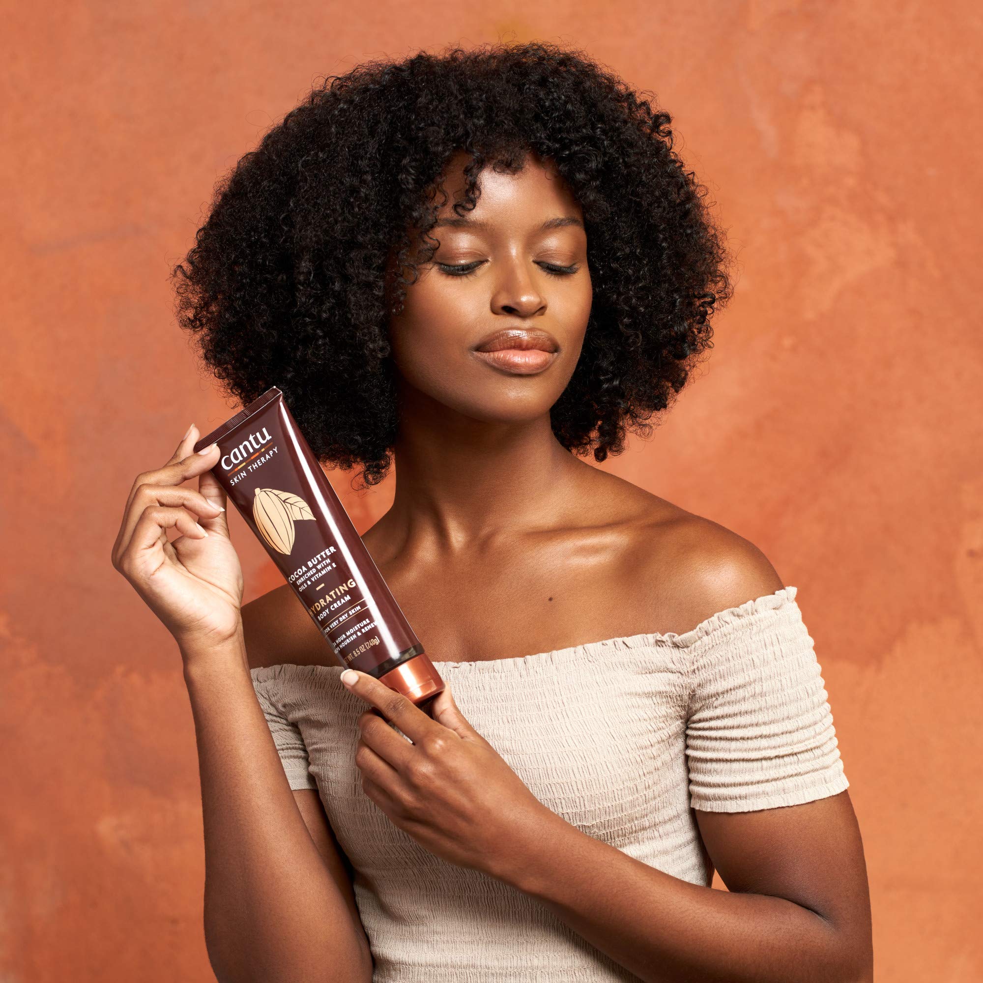 Cantu Therapy Cocoa Butter Body Cream applied by hands demonstrates quick, comfortable moisture