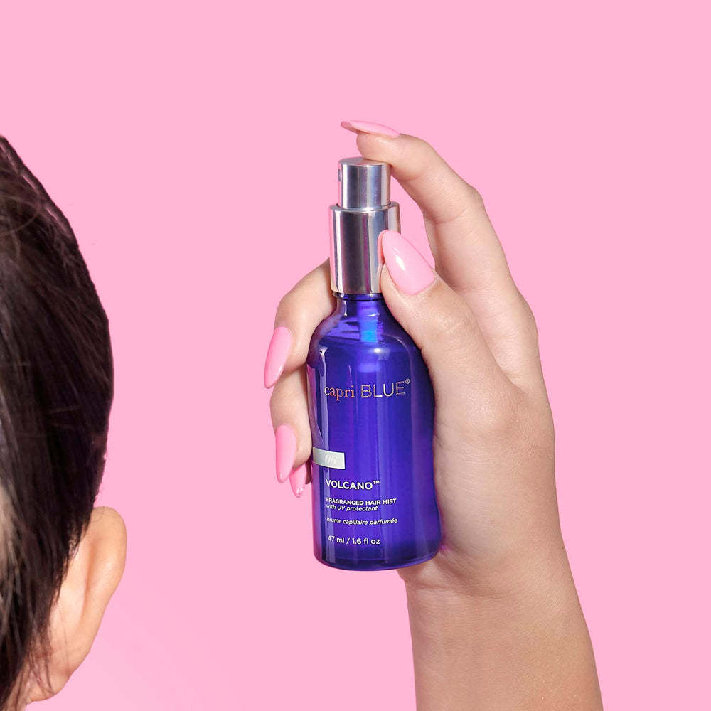Capri Blue Volcano hair mist bottle highlights rice bran oil moisturizing strands.