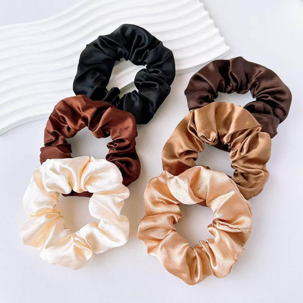 CAZYTOYZ daily-wear satin scrunchies arranged for gifting and use.