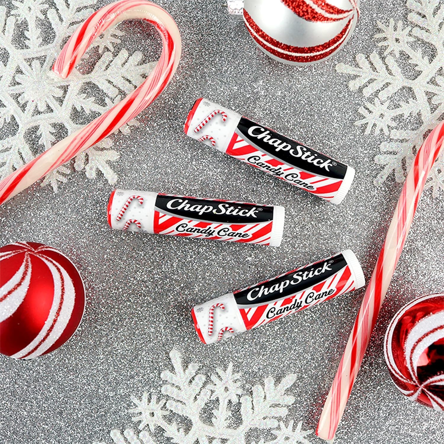 Stocking stuffer idea: ChapStick Candy Cane beside holiday decor.
