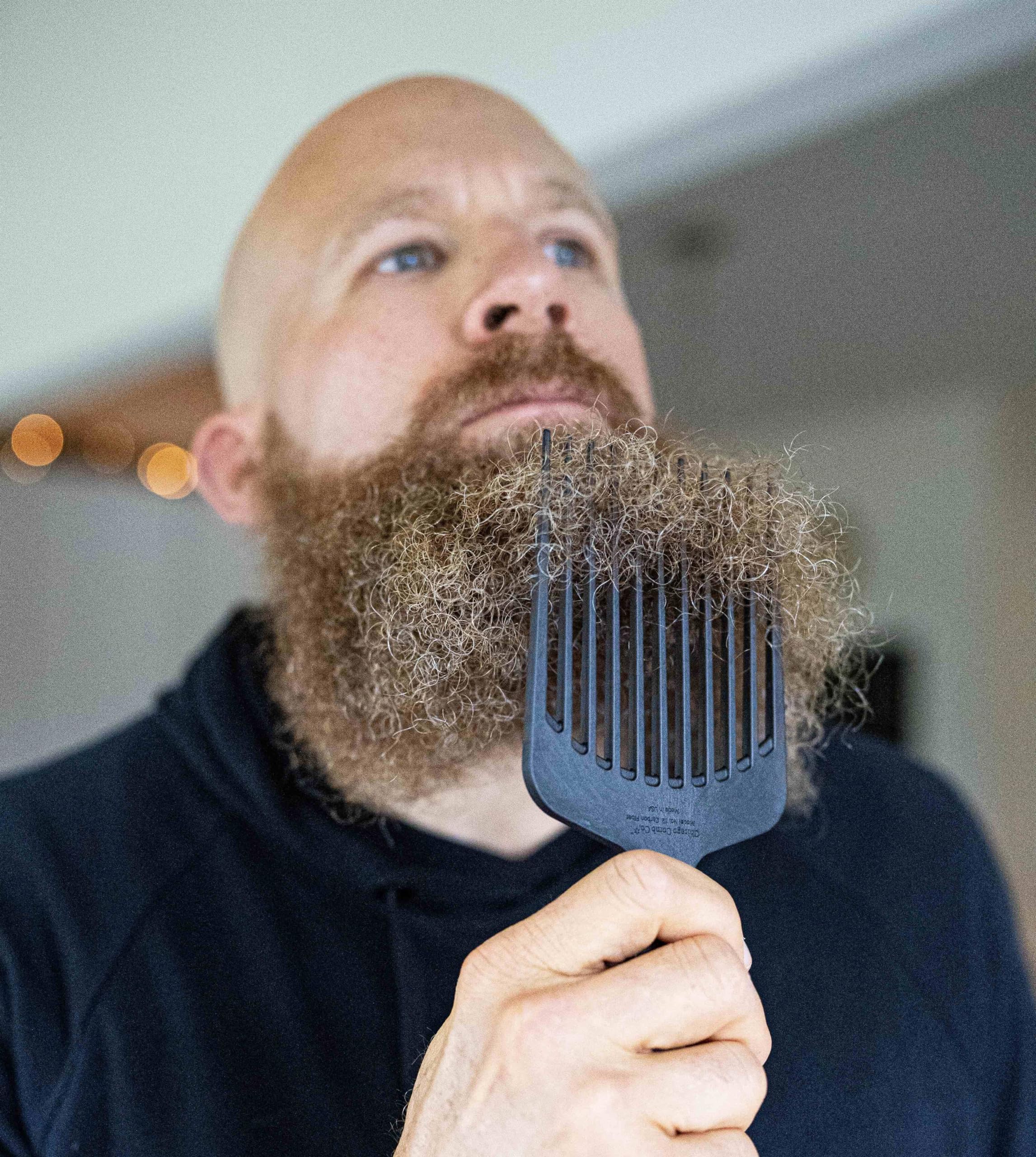 Chicago Comb Model 12 carbon fiber pick in hand for detangling